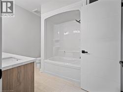 Bathroom with vanity and washtub / shower combination - 