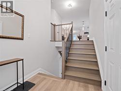 Stairs with wood finished floors and baseboards - 