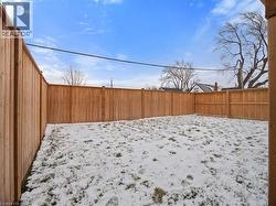Yard covered in snow with a fenced backyard - 