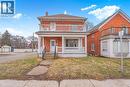 View of front facade featuring a front lawn, a chimney, a porch, and brick siding - 30 Regina Street N, Waterloo, ON  - Outdoor 