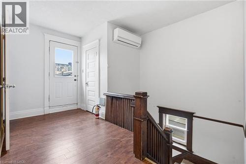 Entrance foyer with hardwood / wood-style floors and a wall mounted mini split - 30 Regina Street N, Waterloo, ON - Indoor Photo Showing Other Room