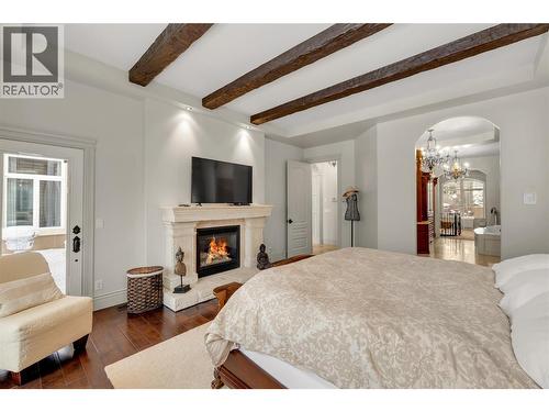 714 Kuipers Crescent, Kelowna, BC - Indoor Photo Showing Bedroom With Fireplace