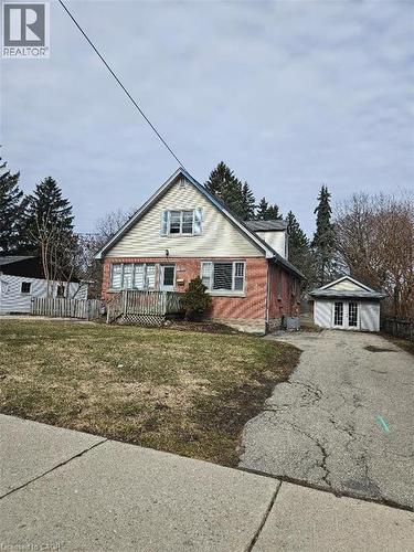 Bungalow with asphalt driveway, an outdoor structure, and a wooden deck - 1154 Queens Boulevard, Kitchener, ON - Outdoor