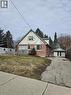 Bungalow with asphalt driveway, an outdoor structure, and a wooden deck - 1154 Queens Boulevard, Kitchener, ON  - Outdoor 
