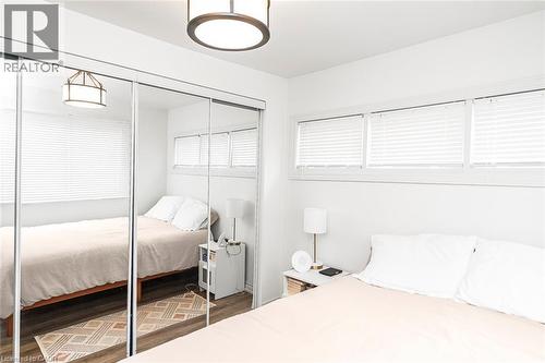 Bedroom featuring a closet and dark wood-style flooring - 57 New Street, Hamilton, ON - Indoor Photo Showing Bedroom