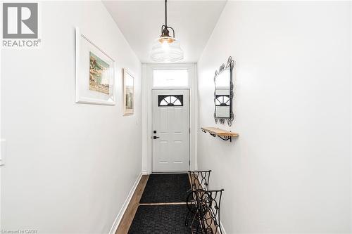 Entryway featuring baseboards and wood finished floors - 57 New Street, Hamilton, ON - Indoor Photo Showing Other Room