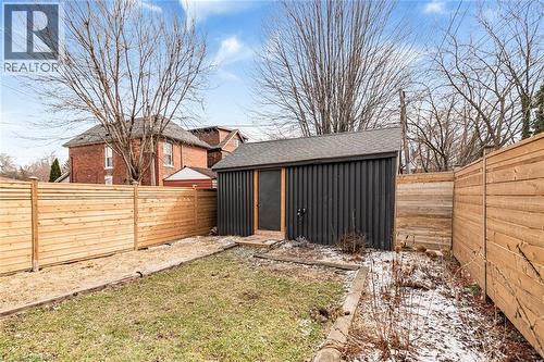 Fenced backyard with a shed - 57 New Street, Hamilton, ON - Outdoor