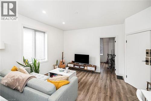Living room featuring wood finished floors and recessed lighting - 57 New Street, Hamilton, ON - Indoor Photo Showing Living Room