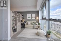Sitting room with light wood finished floors and built in study area - 