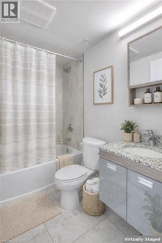 Bathroom with vanity, shower / bath combination with curtain, and light tile patterned flooring - 257 Hemlock Street Unit# 607, Waterloo, ON - Indoor Photo Showing Bathroom