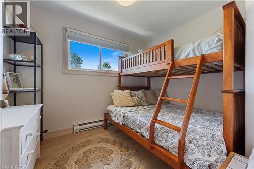 Bedroom with a baseboard heating unit and light wood-type flooring - 181 Cedar Drive, Turkey Point, ON - Indoor Photo Showing Bedroom
