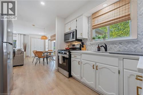 Kitchen with appliances with stainless steel finishes, white cabinetry, plenty of natural light, decorative backsplash, and recessed lighting - 181 Cedar Drive, Turkey Point, ON - Indoor Photo Showing Kitchen