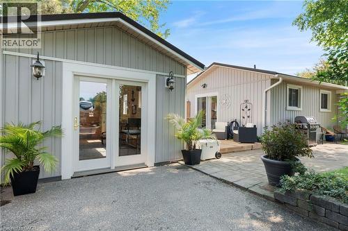 Rear view of property featuring a patio and board and batten siding - 181 Cedar Drive, Turkey Point, ON - Outdoor