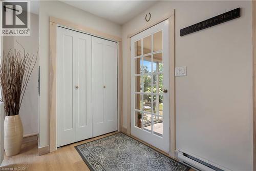 Entrance foyer featuring a baseboard radiator and light wood-type flooring - 181 Cedar Drive, Turkey Point, ON - Indoor Photo Showing Other Room