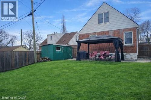 Rear view of property featuring a fenced backyard, a patio area, a gazebo, brick siding, and a storage unit - 226 Auburn Avenue, Hamilton, ON - Outdoor