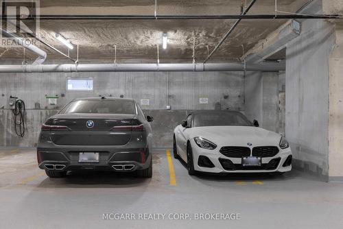 Street level double indoor parking - 401 - 77 Yates Street, St. Catharines (Downtown), ON - Indoor Photo Showing Garage