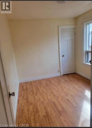 Unfurnished room with light wood finished floors and baseboards - 51 East 16Th Street, Hamilton, ON - Indoor Photo Showing Other Room