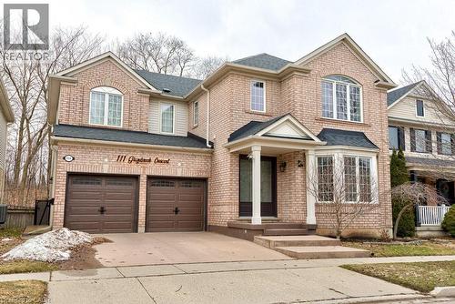 View of front of home with driveway, a garage, a shingled roof, and brick siding - 111 Glazebrook Crescent, Cambridge, ON - Outdoor With Facade