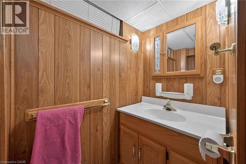 Bathroom with vanity and wood walls - 19 Burfield Avenue, Hamilton, ON - Indoor Photo Showing Bathroom
