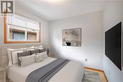Bedroom featuring baseboards and a textured ceiling (virtually staged) - 