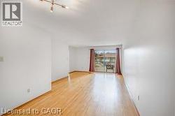 Original room with light wood-type flooring and suspended lighting - 