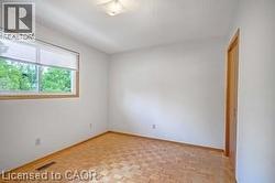 Original room featuring parquet flooring and a textured ceiling - 