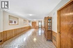 Empty room with wooden walls and a wainscoted wall - 
