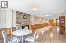 Dining room featuring wainscoting, wood walls, and a fireplace - 