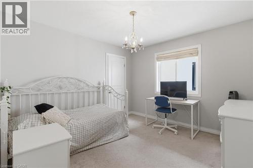 Bedroom with a desk, light carpet, and suspended lighting - 84 Duncairn Crescent, Hamilton, ON - Indoor Photo Showing Bedroom
