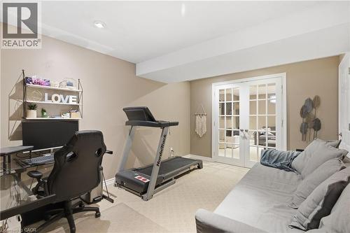 Office area with light colored carpet and french doors - 84 Duncairn Crescent, Hamilton, ON - Indoor Photo Showing Gym Room