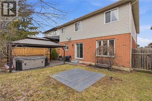 Rear view of house with brick siding, a patio, a gazebo, a fenced backyard, and entry steps - 84 Duncairn Crescent, Hamilton, ON - Outdoor With Exterior