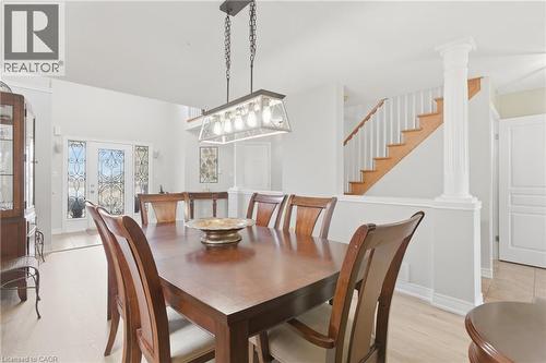 Dining area featuring ornate columns, light wood finished floors, and french doors - 84 Duncairn Crescent, Hamilton, ON - Indoor Photo Showing Dining Room