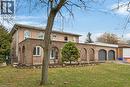 View of front facade featuring a front lawn, brick siding, driveway, and an attached garage - 22 Woodside Drive, Hamilton, ON  - Outdoor 