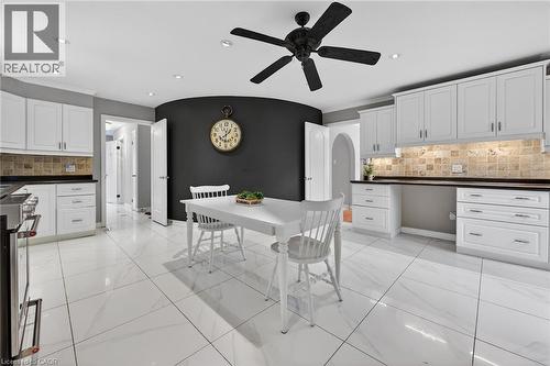 Dining area with recessed lighting, a ceiling fan, arched walkways, and light marble finish flooring - 22 Woodside Drive, Hamilton, ON - Indoor Photo Showing Kitchen With Upgraded Kitchen