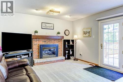 Main level family room with natural gas fireplace - 12 Miller Crescent, Simcoe, ON - Indoor Photo Showing Living Room With Fireplace