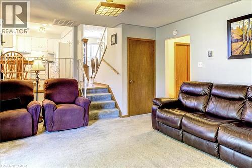 Cozy family room is open to the kitchen. - 12 Miller Crescent, Simcoe, ON - Indoor Photo Showing Living Room