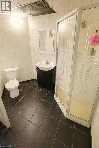 Bathroom featuring vanity, a shower stall, tile walls, and dark tile patterned floors - 988 Prosperity Court, London, ON - Indoor Photo Showing Bathroom