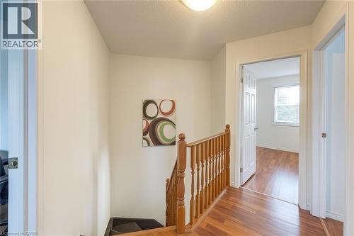 Corridor featuring an upstairs landing, wood finished floors, and a textured ceiling - 988 Prosperity Court, London, ON - Indoor Photo Showing Other Room