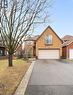 Traditional-style house with asphalt driveway, brick siding, and an attached garage - 4516 Gullfoot Circle, Mississauga, ON  - Outdoor With Facade 