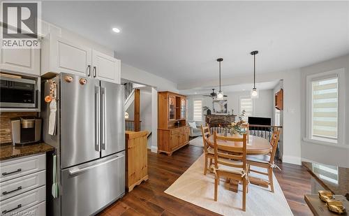 Dining space featuring dark wood finished floors, a ceiling fan, recessed lighting, and a stone fireplace - 4516 Gullfoot Circle, Mississauga, ON - Indoor