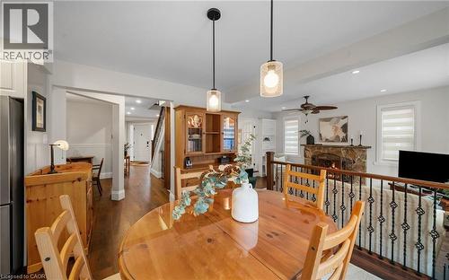 Dining area featuring a stone fireplace, dark wood-type flooring, ceiling fan, and recessed lighting - 4516 Gullfoot Circle, Mississauga, ON - Indoor Photo Showing Dining Room