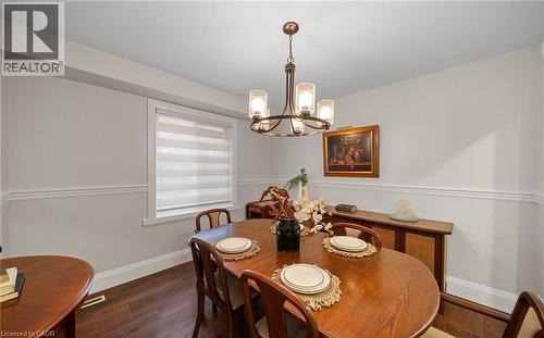 Dining room with a chandelier and wood finished floors - 4516 Gullfoot Circle, Mississauga, ON - Indoor Photo Showing Dining Room