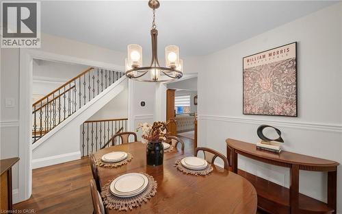 Dining space featuring a chandelier and wood finished floors - 4516 Gullfoot Circle, Mississauga, ON - Indoor Photo Showing Dining Room