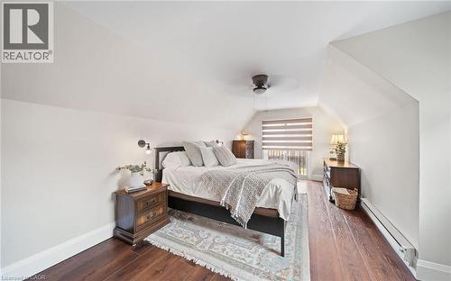 Bedroom featuring a baseboard heating unit, dark wood finished floors, vaulted ceiling, and a ceiling fan - 4516 Gullfoot Circle, Mississauga, ON - Indoor Photo Showing Bedroom