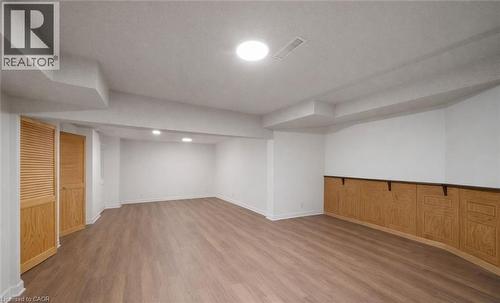 Finished below grade area featuring wood finished floors and a textured ceiling - 4516 Gullfoot Circle, Mississauga, ON - Indoor Photo Showing Other Room