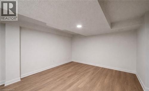 Finished below grade area featuring wood finished floors, a textured ceiling, and recessed lighting - 4516 Gullfoot Circle, Mississauga, ON - Indoor Photo Showing Other Room