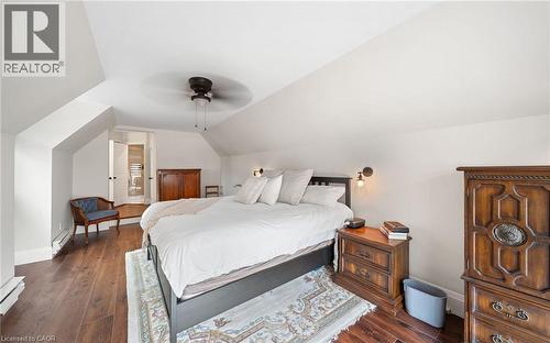 Bedroom featuring dark wood-type flooring, vaulted ceiling, ensuite bathroom, ceiling fan, and baseboard heating - 4516 Gullfoot Circle, Mississauga, ON - Indoor Photo Showing Bedroom
