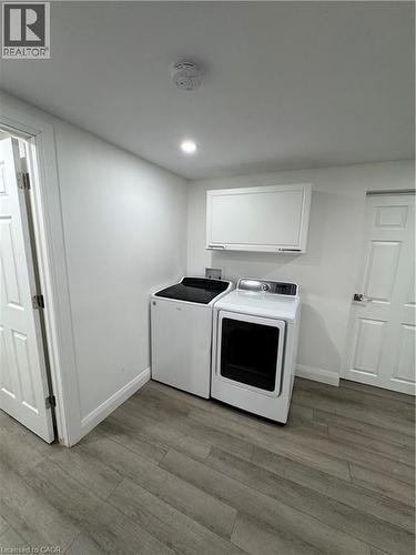 Laundry room featuring light wood finished floors, separate washer and dryer, and recessed lighting - 18 Cyprus Drive Unit# Lower, Kitchener, ON - Indoor Photo Showing Laundry Room