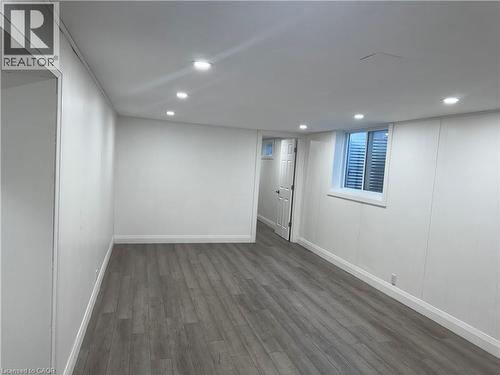 Finished below grade area featuring recessed lighting and dark wood-style floors - 18 Cyprus Drive Unit# Lower, Kitchener, ON - Indoor