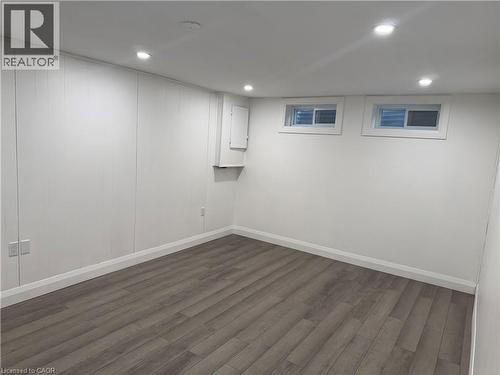 Finished below grade area featuring dark wood finished floors and recessed lighting - 18 Cyprus Drive Unit# Lower, Kitchener, ON - Indoor